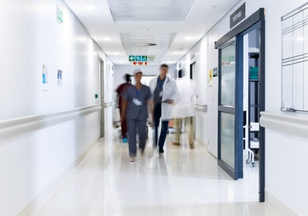 Medical staff in a hospital corridor, illustrating the cybersecurity challenges faced by healthcare organizations.