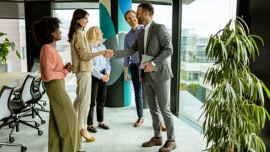Un professionnel serrant la main d'une nouvelle recrue dans un bureau moderne, illustrant le service d'onboarding proposé par Beaver IT.