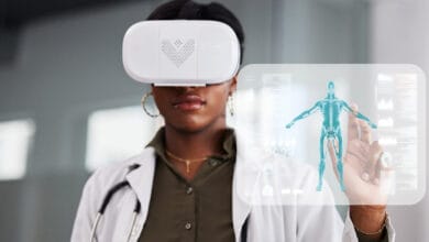 Médecin utilisant des lunettes de réalité virtuelle pour interagir avec une interface holographique, illustrant la transition numérique dans le secteur de la santé.